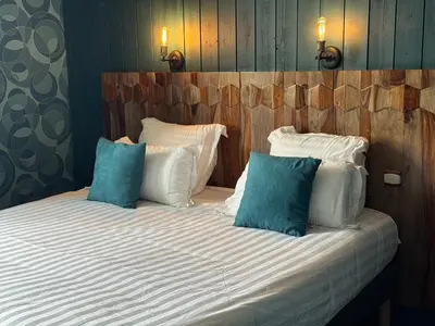 Un ou plusieurs lits dans un hébergement de l'établissement Le Beaulieu - Hôtel et Restaurant - Logis Hôtels