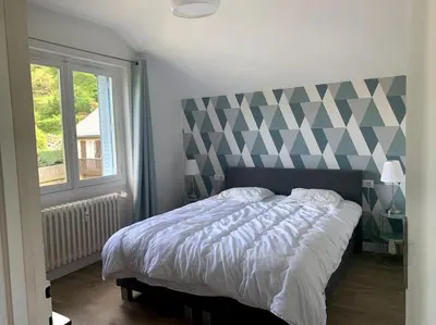 Un ou plusieurs lits dans un hébergement de l'établissement Le Nid des Fées appartement T3 rénové accès jardin