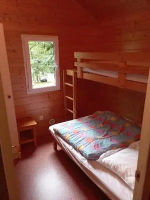 Un ou plusieurs lits dans un hébergement de l'établissement Chalet les Hameaux du Perrier