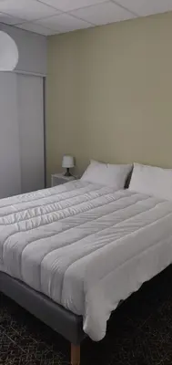 Un ou plusieurs lits dans un hébergement de l'établissement Hôtel Le Millésime