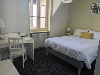 Un ou plusieurs lits dans un hébergement de l'établissement Hôtel Le Millésime