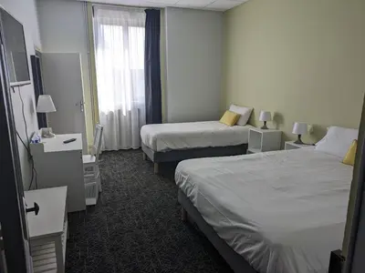 Un ou plusieurs lits dans un hébergement de l'établissement Hôtel Le Millésime