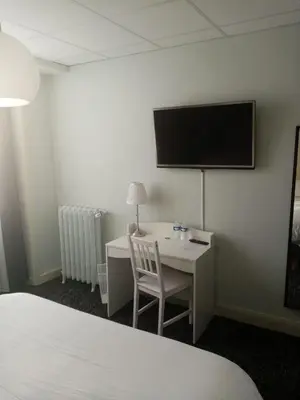Un ou plusieurs lits dans un hébergement de l'établissement Hôtel Le Millésime