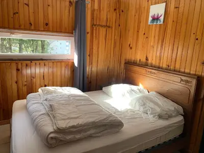 Un ou plusieurs lits dans un hébergement de l'établissement RDC Appartement dans chalet Le Genestou