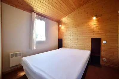 Un ou plusieurs lits dans un hébergement de l'établissement Cottages du Lac de Miel