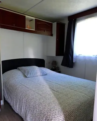 Un ou plusieurs lits dans un hébergement de l'établissement Mobile Home Auvergne