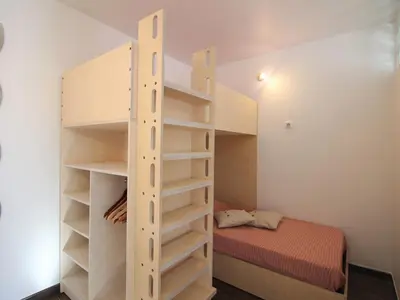 Un ou plusieurs lits dans un hébergement de l'établissement Appartement T2 avec WiFi, proche thermes, 4 pers, Mont-Dore - FR-1-608-252