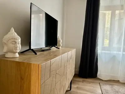 Télévision ou salle de divertissement dans l'établissement Le Quatorze