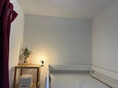Un ou plusieurs lits dans un hébergement de l'établissement Super Besse chez Sophie 2ch, séjour, wifi, 2tv, rdc, terrasse, parc, piscine, pkg