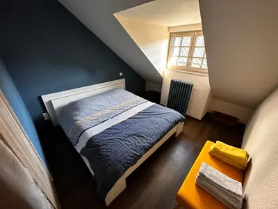 Un ou plusieurs lits dans un hébergement de l'établissement La Maison aux Volets Bleus 3ème Étage