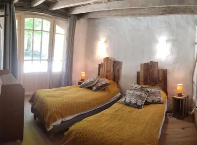 Un ou plusieurs lits dans un hébergement de l'établissement Le cottage des Acacias