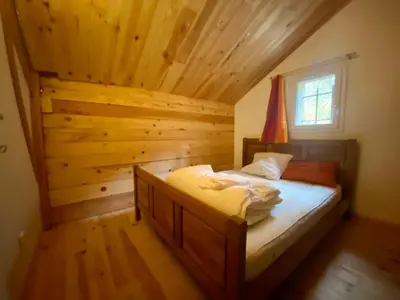 Un ou plusieurs lits dans un hébergement de l'établissement Chalet vue lac