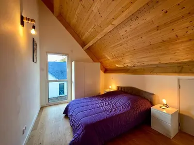 Un ou plusieurs lits dans un hébergement de l'établissement Chalet 5 pièces avec terrasse et garage au Mont-Dore - FR-1-608-263