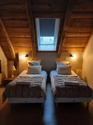 Un ou plusieurs lits dans un hébergement de l'établissement Gîte du Milan royal