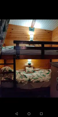 Un ou plusieurs lits dans un hébergement de l'établissement Charmant Mobil home style chalet