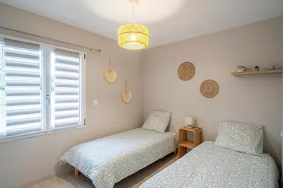 Un ou plusieurs lits dans un hébergement de l'établissement L'Escapade du Petit Mas - Appt climatisé