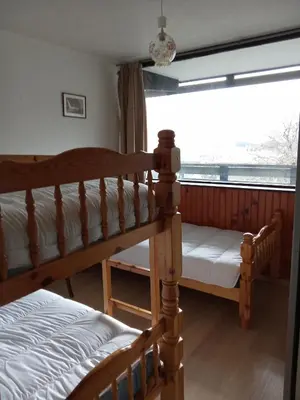 Un ou plusieurs lits dans un hébergement de l'établissement Appartement plein cœur Super-Besse