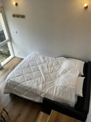 Un ou plusieurs lits dans un hébergement de l'établissement Gîte au bord du lac