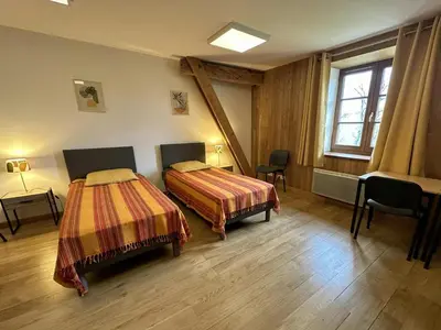 Un ou plusieurs lits dans un hébergement de l'établissement La murette