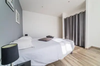 Un ou plusieurs lits dans un hébergement de l'établissement Le Balcon - 2 Chambres