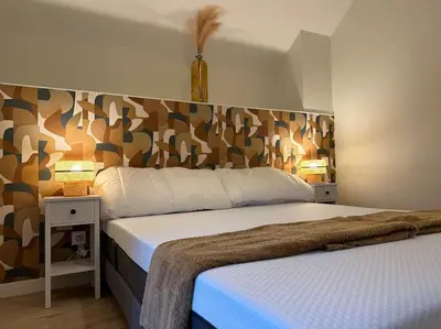 Un ou plusieurs lits dans un hébergement de l'établissement Maison avec cour intérieure