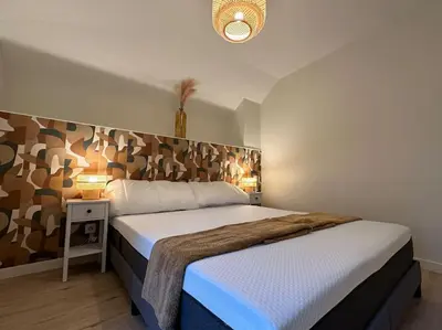 Un ou plusieurs lits dans un hébergement de l'établissement Maison avec cour intérieure