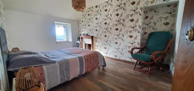 Un ou plusieurs lits dans un hébergement de l'établissement Location petite maison