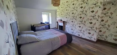 Un ou plusieurs lits dans un hébergement de l'établissement Location petite maison
