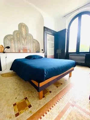 Un ou plusieurs lits dans un hébergement de l'établissement Maison Art Deco Calme en centre ville