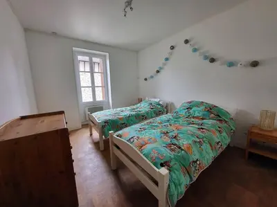 Un ou plusieurs lits dans un hébergement de l'établissement La libellule Pelaude Appartement 4-6 personnes avec terrasse