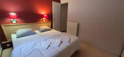 Un ou plusieurs lits dans un hébergement de l'établissement Village Montanha Lioran