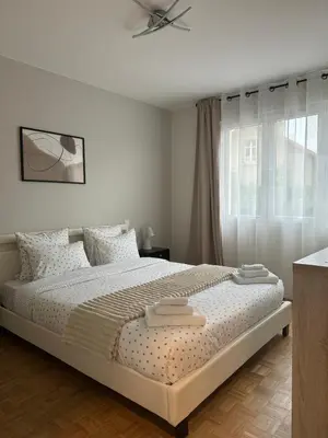 Un ou plusieurs lits dans un hébergement de l'établissement Appartement chaleureux et spacieux T3