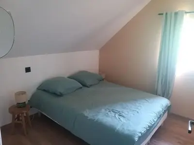 Un ou plusieurs lits dans un hébergement de l'établissement Gîte confortable à la campagne