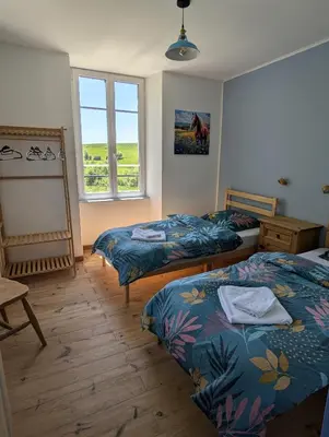 Un ou plusieurs lits dans un hébergement de l'établissement Ferme Équestre Equi'Cantal