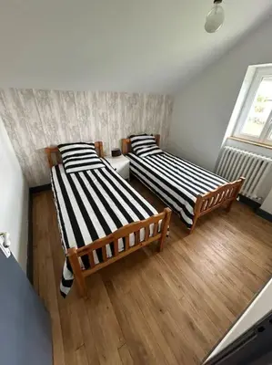 Un ou plusieurs lits dans un hébergement de l'établissement Maison le Ragean