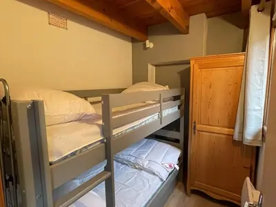 Un ou plusieurs lits dans un hébergement de l'établissement Duplex au Lioran avec balcon, proche pistes et commerces - FR-1-787-25