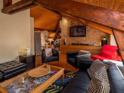 Coin salon dans l'établissement Appartement duplex le montagne de la villa Chanterive