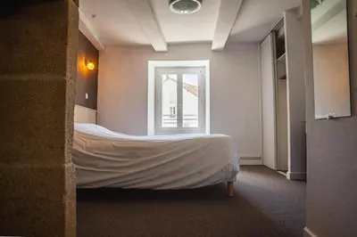 Un ou plusieurs lits dans un hébergement de l'établissement Logis Hotel Eben