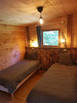 Un ou plusieurs lits dans un hébergement de l'établissement Gîte nature La clairière