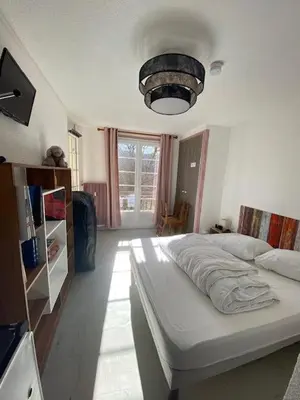 Un ou plusieurs lits dans un hébergement de l'établissement Appartement avec chambre séparée Résidence Auvergne