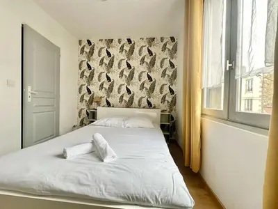 Un ou plusieurs lits dans un hébergement de l'établissement Le Saint Georges, cosy et calme