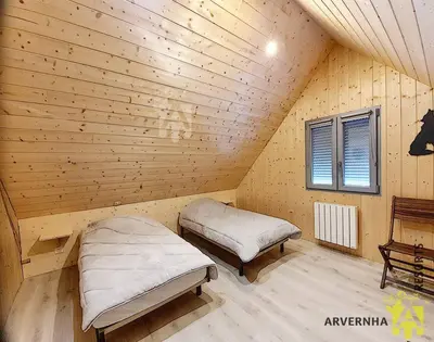 Un ou plusieurs lits dans un hébergement de l'établissement Chalet Caranne