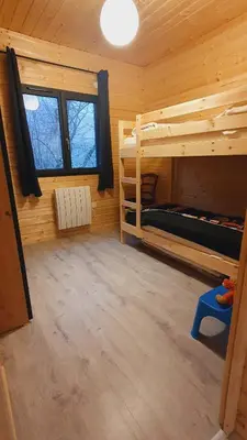 Un ou plusieurs lits dans un hébergement de l'établissement Le Chalet du Grand Megnaud