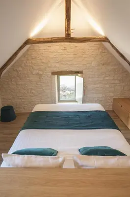 Un ou plusieurs lits dans un hébergement de l'établissement Les maisons du boulanger