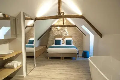Un ou plusieurs lits dans un hébergement de l'établissement Les maisons du boulanger