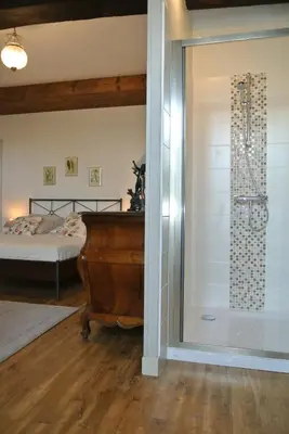 Un ou plusieurs lits dans un hébergement de l'établissement Chambre d'hôtes Au jardin de la Bachellerie