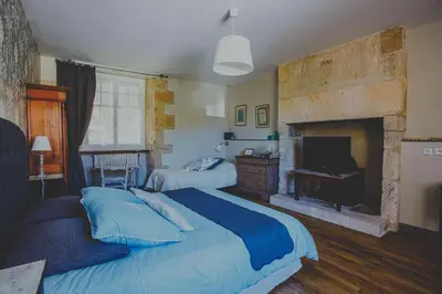 Un ou plusieurs lits dans un hébergement de l'établissement Chambre d'hôtes Au jardin de la Bachellerie