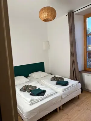 Un ou plusieurs lits dans un hébergement de l'établissement Appartement face au château