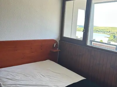 Un ou plusieurs lits dans un hébergement de l'établissement Appartement rénové au cœur de Super Besse avec balcon et parking privé - FR-1-814-81