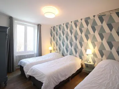 Un ou plusieurs lits dans un hébergement de l'établissement Appart T3 lumineux, 5 pers, jardin, wifi, La Bourboule - FR-1-608-283